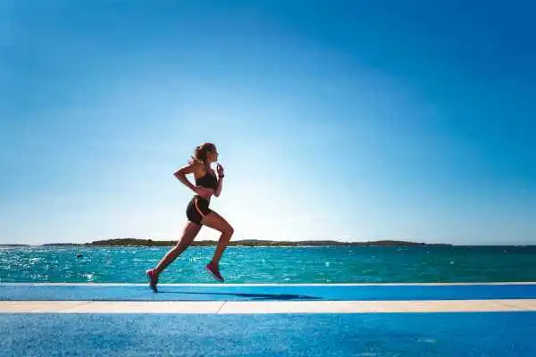 Woman running showing strong leg muscle Spring Vale